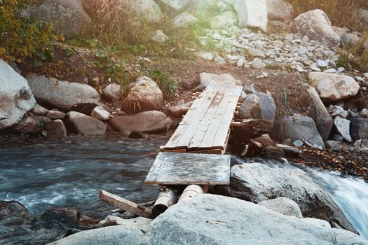 Wooden bridge over small river. Horizontal photo