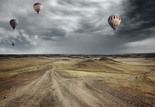 Air balloons flying over the country road