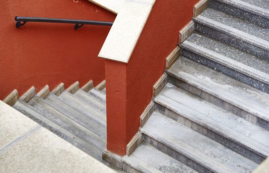 Marble staircase with red walls. View from above