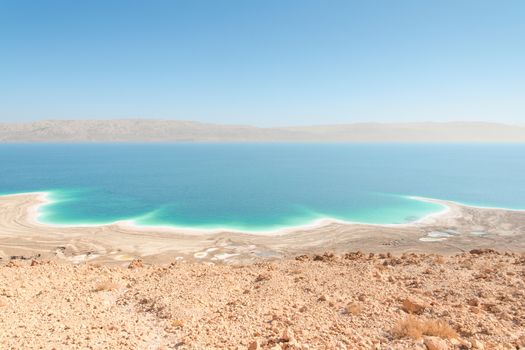 Exotic landscape in desert Dead Sea shoreline aerial view with range of high mountains on opposite shore