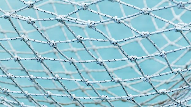 Yacht safety nets of sailing yacht and ocean background.