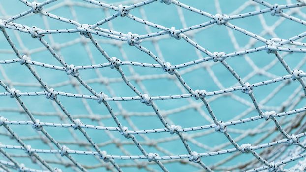 Yacht safety nets of sailing yacht and ocean background.