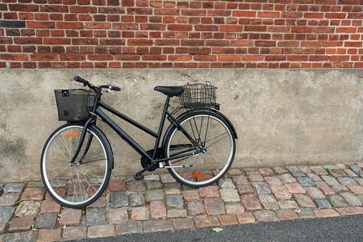 Vintage Classical  Black Bicycle in front of an old house Denmark                               