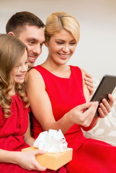 family, christmas, happiness, technology and people concept - smiling family with tablet pc