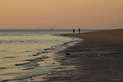 At the beach in thailand in summer at sunset, view on the sea