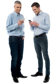 Casual men operating their new mobile phone
