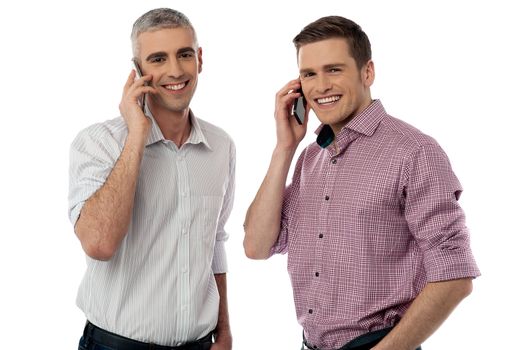 Casual smiling men communicate via cell phone