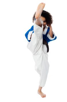 Image of a little girl practice karate over white