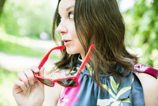 Happy young woman outdoors with sunglasses 