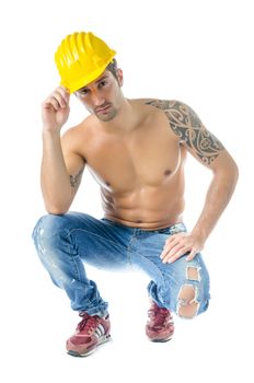 Handsome, muscular construction worker shirtless wearing jeans and hard hat, isolated on white
