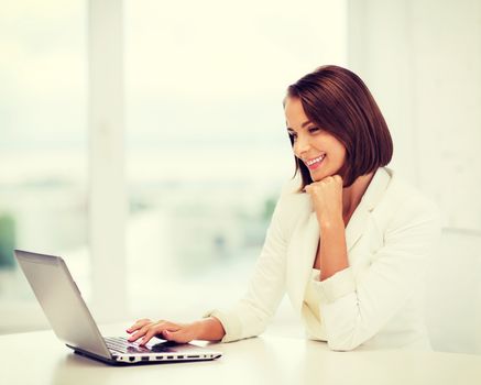 business and technology concept - businesswoman with laptop in office