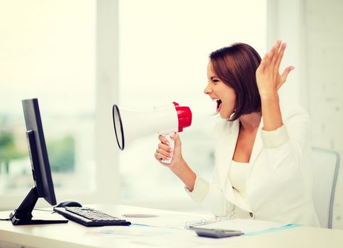 business and technology concept - strict businesswoman shouting in megaphone in office