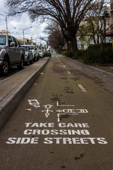 Painted road sign on asphalt