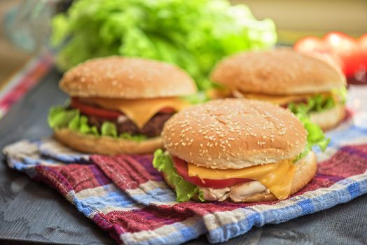 Closeup of home made burgers on wooden table