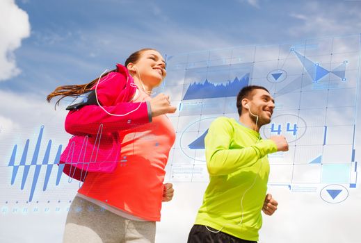 fitness, sport, friendship and lifestyle concept - smiling couple with earphones running outdoors