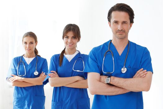 team of doctors in blue scrubs