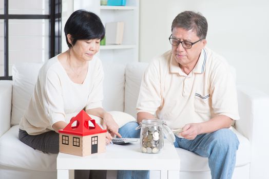 Asian senior couple counting on money. Saving, retirement plan, retirees financial planning concept. Family living lifestyle at home.