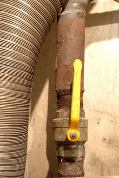 Old yellow valve and two pipes