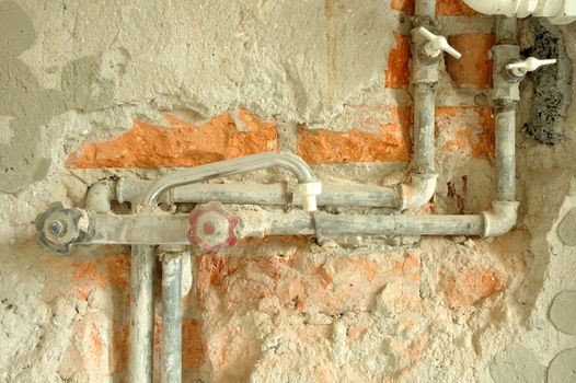 Old cock, valves and pipes inside wall