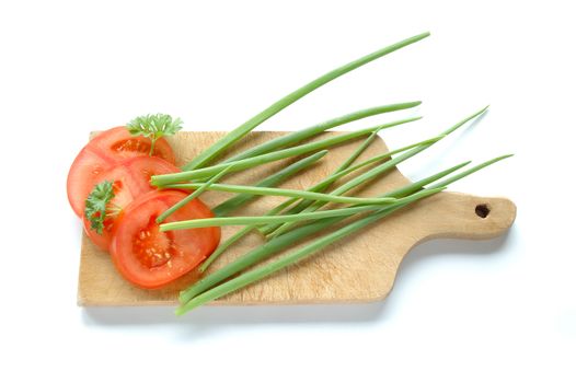 Vegetables on chopping board on white background