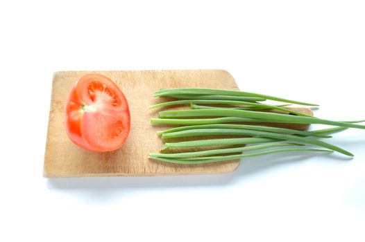 Vegetables on chopping board on white background