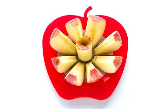 Apple cut into pieces with special cutting device on white background
