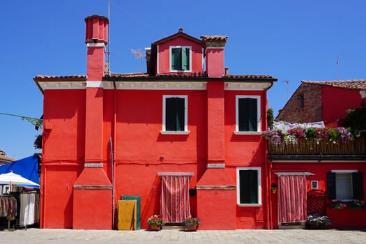 Burano colorful building architecture in red, Venice, Italy