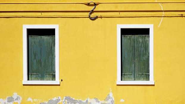 green woodem Window on yellow wall building architecture in Burano , Venice, Italy