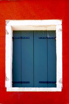 House Window with white frame in Burano on colorful wall building architecture, Venice, Italy