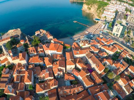 View of old town Budva from the top: Ancient walls and tiled roof of old town Budva, Montenegro, Europe. Aerial shoot