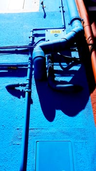 metal pipe and electric box on blue color wall in Burano, Venice, Italy