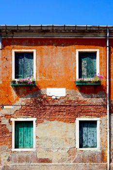 2 doors and 2 windows ancient building architecture in Murano, Venice, Italy