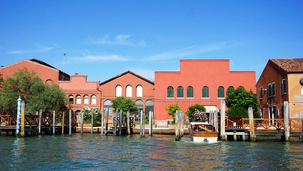 building architecture, pier boats and canal in Murano, Venice, Italy