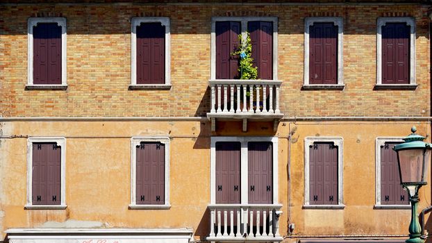 windows doors and terrace of ancient house in Murano, Venice, Italy