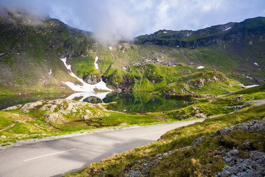 Idyllic view with on Balea Lake shore seen from Transfagarasan road in Fagaras Mountains, Romania.