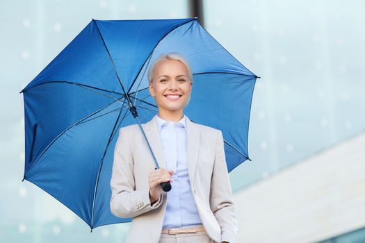 business, bad weather and people and concept - young smiling businesswoman with umbrella outdoors