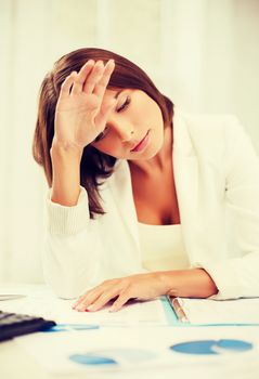business and education concept - bored and tired woman with documents