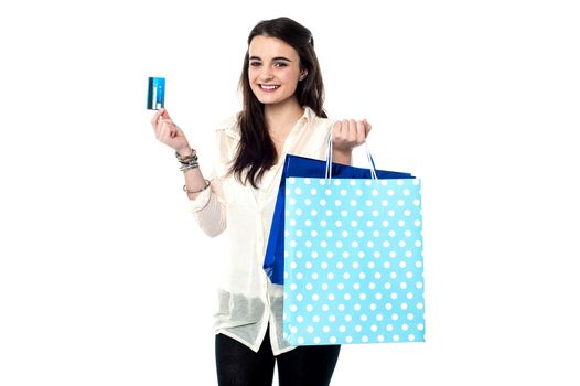 Teen girl showing credit card after her shopping