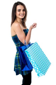 Trendy girl with polka dots shopping bags