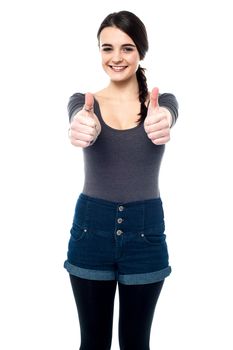 Teen girl making thumbs up gesture by two hands