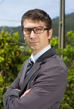 handsome businessman with glasses outdoors