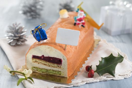Yule log of white chocolate mousse, stuffed with raspberry puree sponge rolls, glazed with raspberry jelly