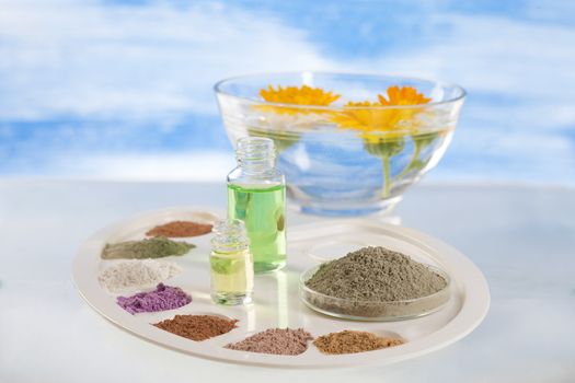 Body care and spa treatment concept, range of coloured french clay and essential oil for mud therapy