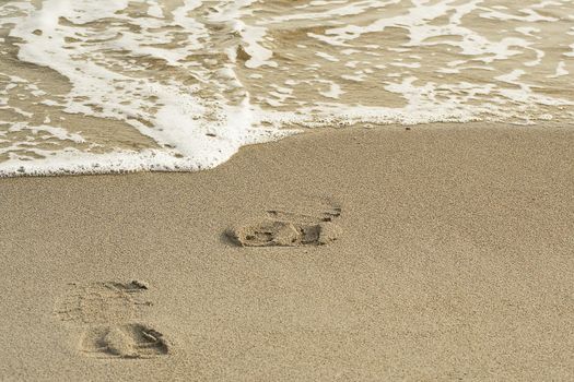 footprints on the sand of shoes man