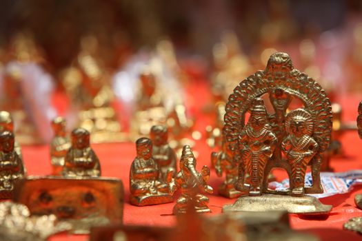 The brass idols of lord Vitthal and Rakhumai along with other deities for sale in a holy shop in India.