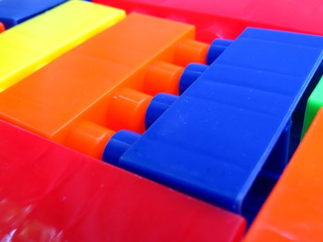 A background of bright colored toy building blocks arranged randomly.                               
