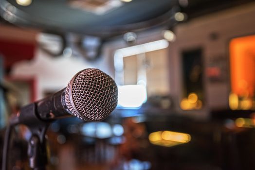 Closeup of audio microphone on stage background