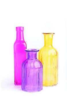 Three colorful bottles, isolated on white background