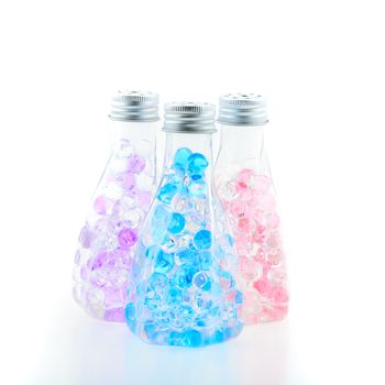 Three colorful bottles with beautiful gelatin inside, isolated on white background