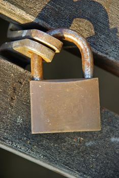 Strong padlock closing a wooden door